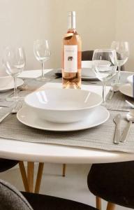 a table with a white plate and a bottle of wine at Blue Dream in Nice