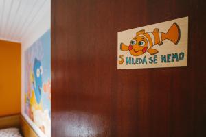 a sign on a door with a fish on it at Chata Ťapka in Dolní Malá Úpa