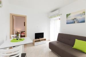 a living room with a couch and a table at Apartments Gabi in Punat
