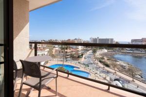a balcony with a table and chairs and a view at AluaSoul Palma Hotel Adults Only in Can Pastilla