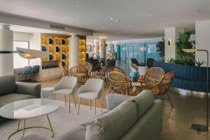 a lobby with couches and chairs and tables at AluaSoul Palma Hotel Adults Only in Can Pastilla