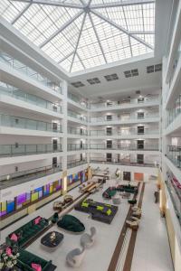 a large building with a lobby with tables and chairs at DoubleTree by Hilton Sarasota Bradenton Airport in Sarasota