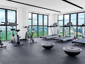 a gym with a bunch of treadmills and exercise bikes at Mercure Kuala Lumpur Trion in Kuala Lumpur