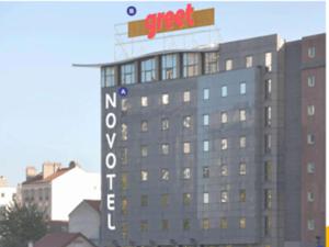 a building with a sign on top of it at greet Hotel Paris 13 Porte d'Italie in Le Kremlin-Bicêtre