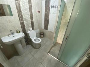 a bathroom with a toilet and a sink and a shower at PORT APART in Antalya