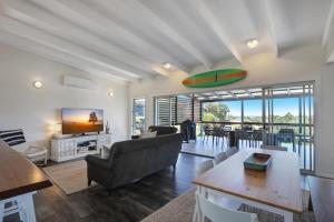 a living room with a couch and a table at Kahala in Point Lookout