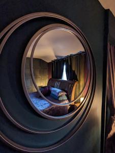 a circular mirror in a room with a bed at Jackson place in Newton Aycliffe