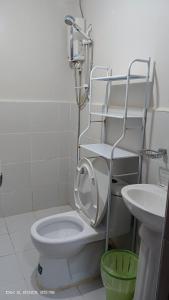 a bathroom with a white toilet and a sink at Tranquil Cool Studio Condo Mactan Cebu in Lapu Lapu City +10 photos