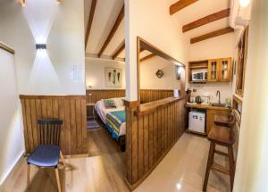 a small bedroom with a bed and a kitchen at Departamentos de turismo - Apart Hotel MiCasa in Futrono +9 photos
