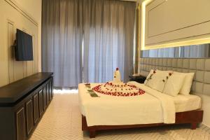 a hotel room with a bed with a cake on it at Hengly Mohasambath Hotel & Spa in Phumĭ Kruŏs