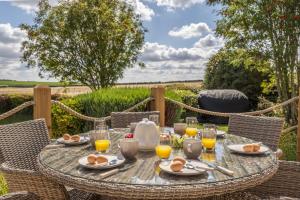 a table with eggs and glasses of orange juice at Larks Rise in Burnham Market