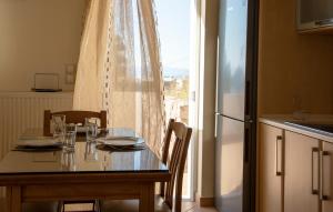 kuchnia ze stołem, krzesłami i lodówką w obiekcie Aegina Sea View Villa w mieście Aegenitissa +25 zdjęć