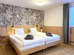 Postel nebo postele na pokoji v ubytování 2Home Hotel Apartments