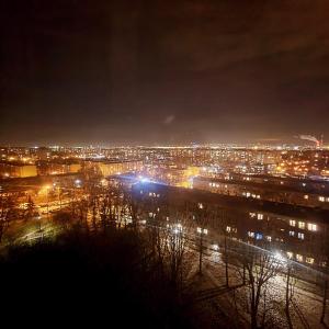 a view of a city at night with lights at Panorama Apartment Kraków in Krakow