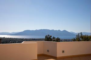 a view of the ocean from the balcony of a house at Aegina Sea View Villa in Aegenitissa