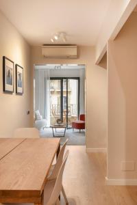 una sala da pranzo con tavolo e sedie e un soggiorno di C211 Barcelona Apartments a Barcellona