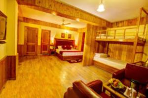 a living room with bunk beds and a couch at Hotel Apple Paradise Manali in Manāli