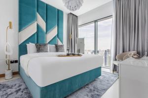 a bedroom with a large bed and a large window at Frank Porter - Vida Residences in Dubai