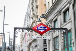 a metro sign on the side of a city street at Feelathome San Marcos Apartments in Madrid