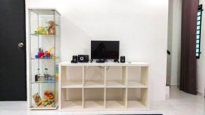 a white shelf with a computer on top of it at D'Sandra Homestay in Kulim