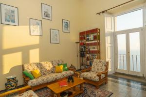 a living room with a couch and two chairs at Palazzo Marchesale, vista mare in Pisciotta