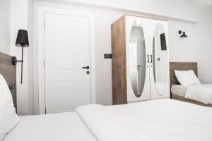 a bedroom with two beds with surfboards on the wall at Begonvil Pansiyon in Çanakkale