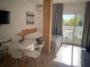 a bedroom with a bed and a table and a dining room at Benalbeach loft in Benalmádena