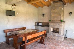 a dining room with a table and a fireplace at Guest House Moiata Kashta in Chernomorets
