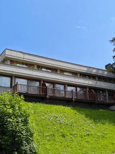 a large building with balconies on a hill at Hostdomus - Sansicario R4 in Cesana Torinese