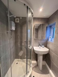 a bathroom with a shower and a sink at Ivy Cottage in Prestatyn