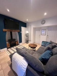 uma sala de estar com um sofá e uma lareira em Ivy Cottage em Prestatyn