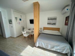 a bedroom with a bed and a table and a desk at Benalbeach loft in Benalmádena +25 photos