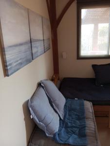 a bedroom with a bed and a window and a pillow at Lakeview Chalet in the Galilee - Master Bedroom Sublet in Kafr Mandā