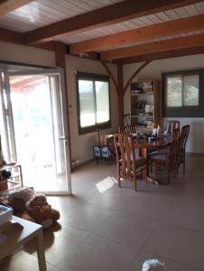 a living room with a dining room table and chairs at Lakeview Chalet in the Galilee - Master Bedroom Sublet in Kafr Mandā