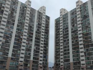 two tall apartment buildings in a city at Subhanallah guest house in Yangsan