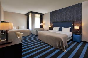 Postel nebo postele na pokoji v ubytování Van der Valk Hotel Sneek