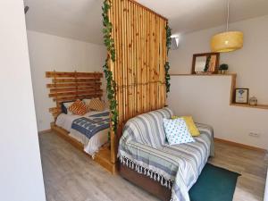 a bedroom with two beds and a couch at Pé n' Areia by Ericeira Property in Carvoeira