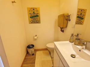 a bathroom with a white sink and a toilet at Pé n' Areia by Ericeira Property in Carvoeira