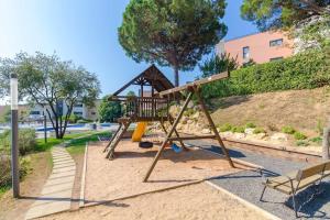 a playground with a slide in a park at Apartamento Ciara in Lloret de Mar