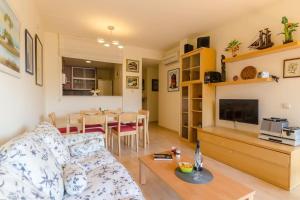 a living room with a couch and a table at Apartamento Ciara in Lloret de Mar