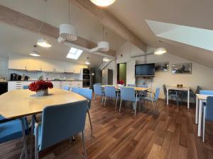 a dining room with tables and blue chairs at Kapten Billes Restaurang och Logi in Norsholm