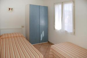 a bedroom with a blue cabinet and a window at Apartments Villa Franca in Capoliveri in Capoliveri