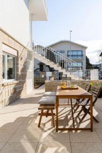 a wooden table and chairs on a patio at Porto Lidador Boutique Ap with Garden - Alvaro in Porto