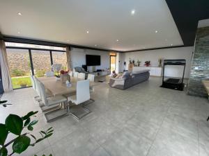 a large living room with a table and a couch at Villa des Grenadelles in Saint-Paul