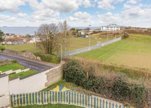 a tennis court on a hill next to a road at Late Rooms at North Devon Resort in Ilfracombe