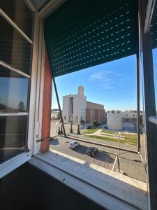 a window with a view of a city street at Sotto il cielo di Ulisse in Sabaudia