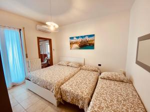 a bedroom with two beds and a window at Lucky’s house in Noicattaro +29 photos