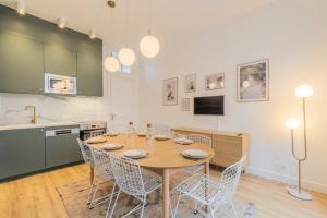 a kitchen and dining room with a table and chairs at 5-bedroom house in the centre of Lille. in Lille