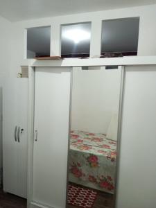 a room with two white cabinets and a bed at Apartamento no Pelourinho in Salvador