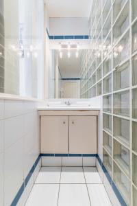 La salle de bains est pourvue d'un lavabo et d'un miroir. dans l'établissement Appartement Paisible Proximité des Halle - 4P, à Paris